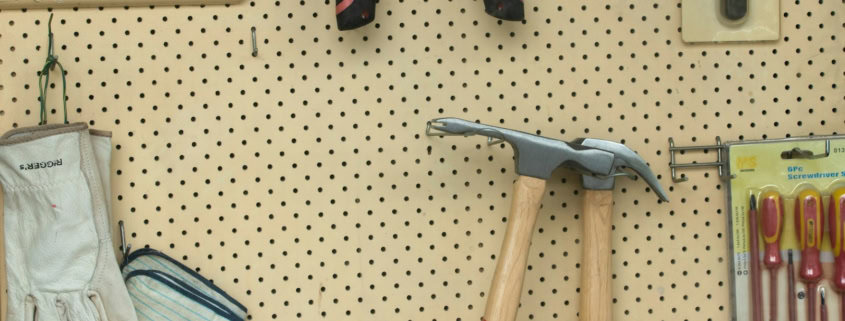 black and silver claw hammer beside red and black hand tool